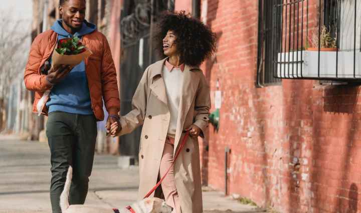 romantic black couple walking with dog